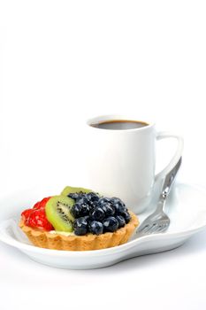 Colorful fruit tart served with a cup of coffee.