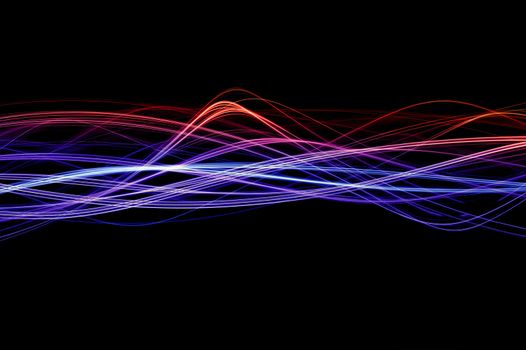 Red, blue and purple waveforms of light on a black background
