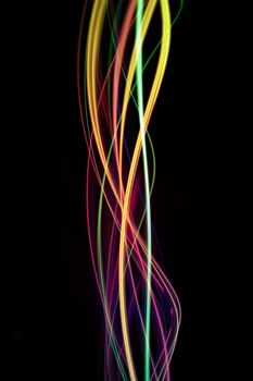 background of colourful twisting lines of color on black