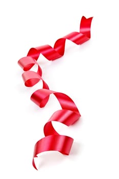 Curled red holiday ribbon strip isolated on white background