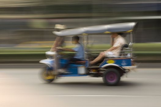 Motion blurred Tuk-Tuk taxi in Bankgkok, Thailand