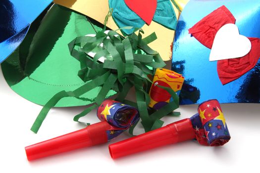 Party hats and party blowers on a plain white background.