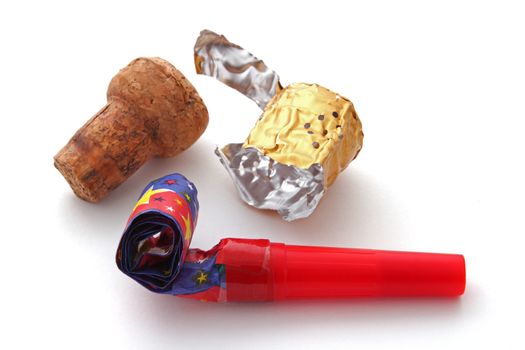 Champagne cork, foil and blower on a plain white background.