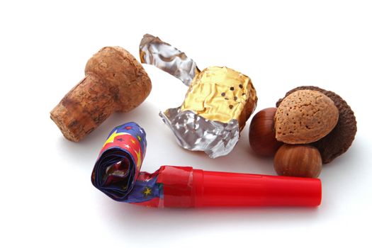 Champagne cork, foil, blower and nuts on a plain white background.