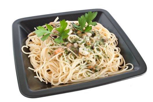 spaghetti with shrimps, squids, mussels and parsley isolated on white with clipping path