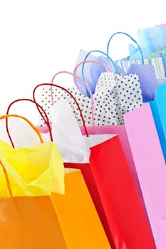 Many colorful shopping bags on white background