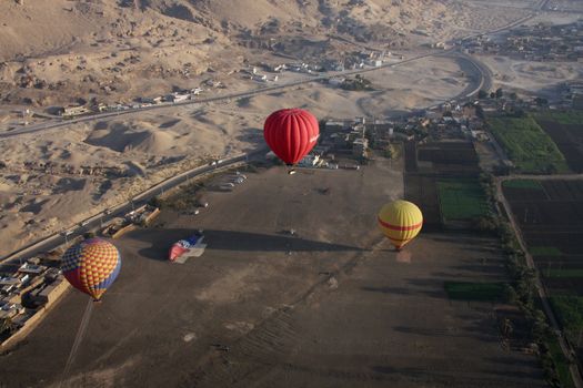 3 Hot air balloons taking off from Luxor Egypt, aerial shot