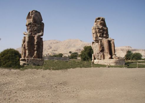 Colossus of Menmon Luxor Egypt, two large statues, clear blue sky