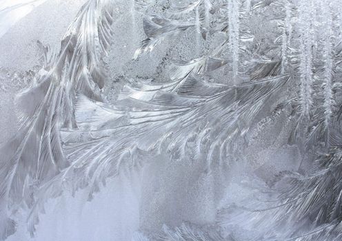 Frost patterns on the window. Winter morning.