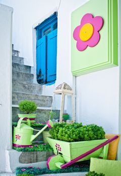 Pots Of Flowers On A White Staircase With A Wicket