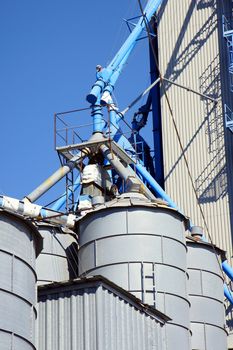 Food industry: grain cereal silos with pipeline vertical close-up with copy space.