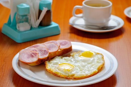 Breakfast. Fried eggs, a sandwich and tea