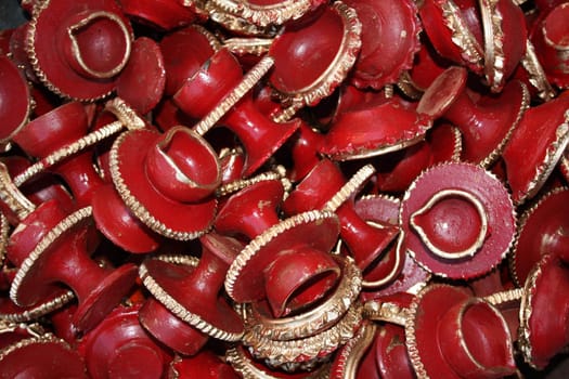 A background of red clay lamps with traditional design for Diwali festival.
