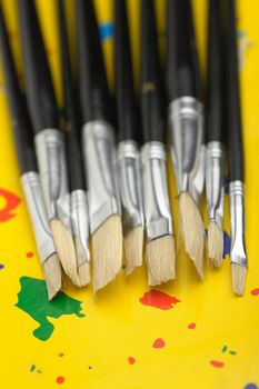 Art brushes close up.On abstract color background