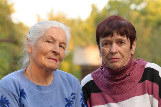 Two sisters of old age. A photo on outdoors