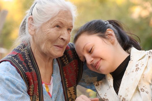 The grandmother with the grand daughter. A photo on outdoors