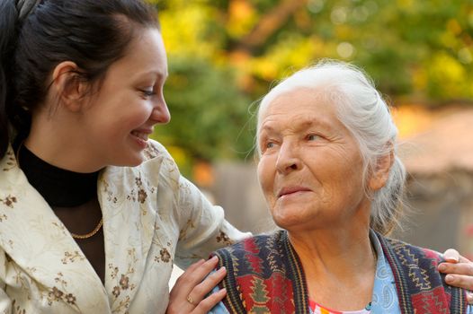 The grandmother with the grand daughter. A photo on outdoors