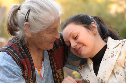 The grandmother with the grand daughter. A photo on outdoors