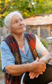 Portrait of the elderly woman. A photo on outdoors