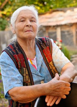 Portrait of the elderly woman. A photo on outdoors