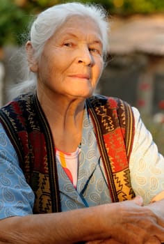 Portrait of the elderly woman. A photo on outdoors