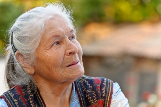 Portrait of the elderly woman. A photo on outdoors