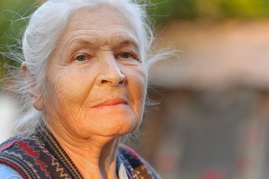 Portrait of the elderly woman. A photo on outdoors