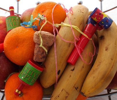 Fruit at a party with party poppers .