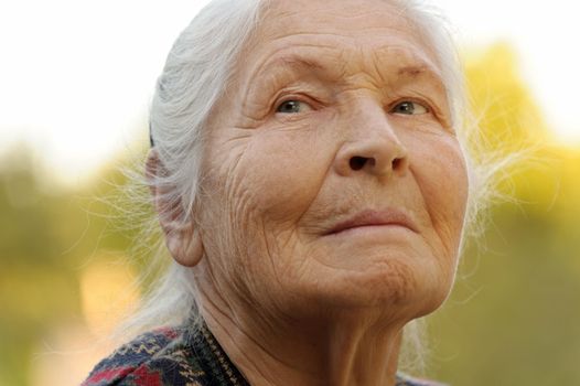 Portrait of the elderly woman. A photo on outdoors