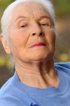 Portrait of the elderly woman. A photo on outdoors