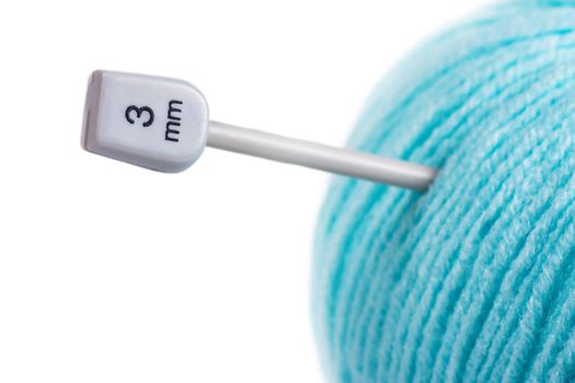 Blue wool ball with knitting needle