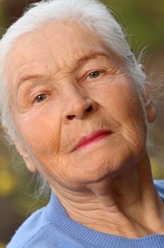 Portrait of the elderly woman. A photo on outdoors