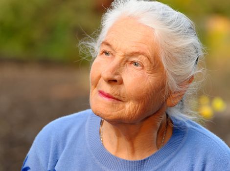 Portrait of the elderly woman. A photo on outdoors