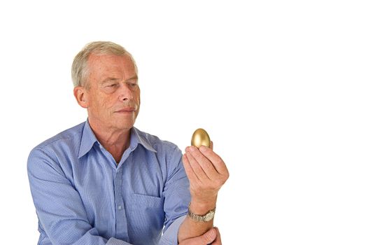 Senior man with his golden egg. His fortune/savings. Pleasent age.