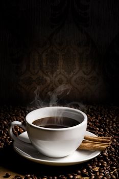 hot cup of coffee, bean and aromatic cinnamon