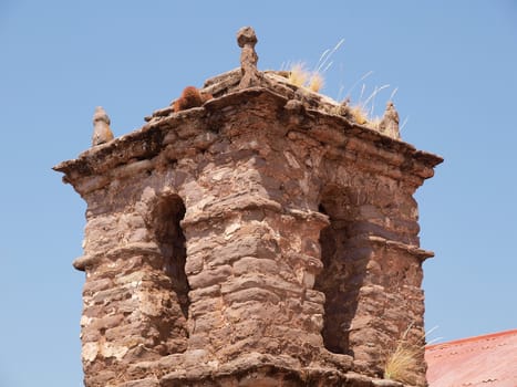 old tower of christian church, build from stone, lake titicaca, peru