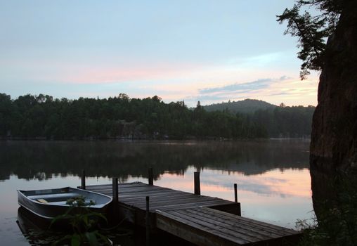 Fisherman on a lake at sunset