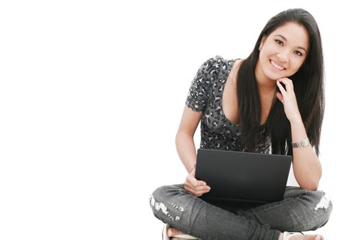 attractive young female sitting on the floor using laptop