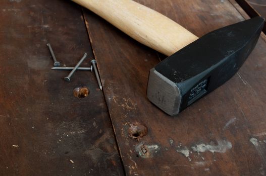 Hammer and Nails on Old Wooden Planks