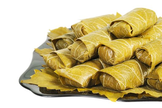 Dolma on a black plate. Isolated on white background.