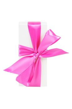 Gift box with a big pink bow. Isolated on white.