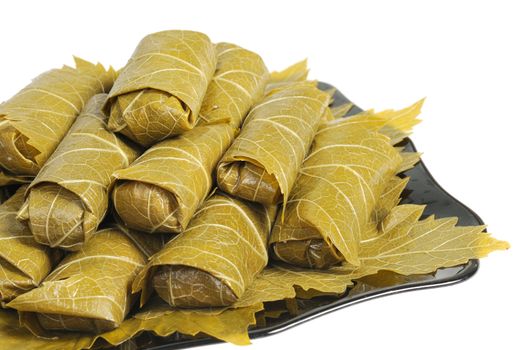 Dolma on a black plate. Isolated on white background.