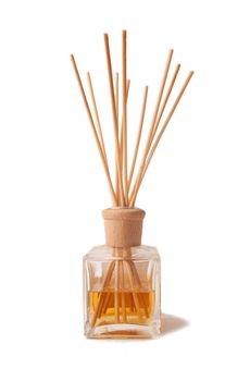 Perfumed incense sticks in an oil jar on white background