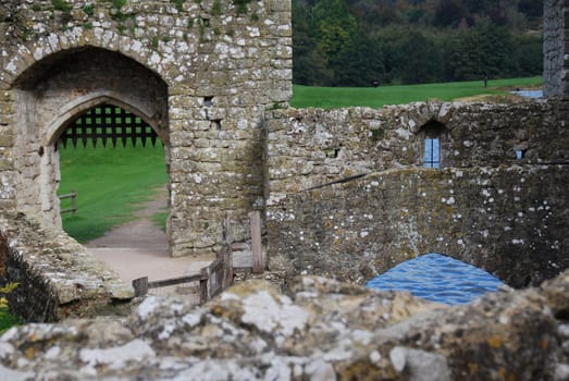 Ruined castle walls and gate above water