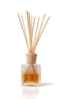 Perfumed incense sticks in an oil jar on white background