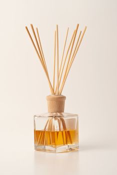 Perfumed incense sticks in an oil jar on clean background