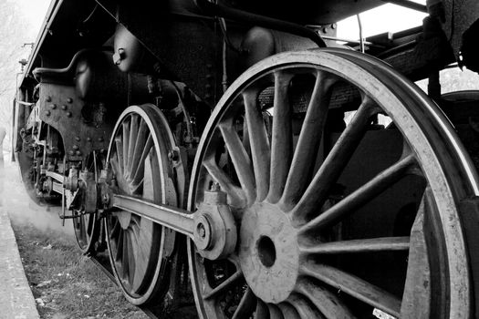 Close up of the wheels and suspension of the old steam engine
