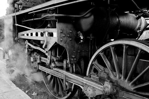 Close up of the wheels and suspension of the old steam engine
