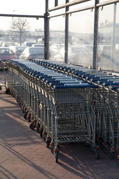 Row of empty shopping carts at the supermarket
