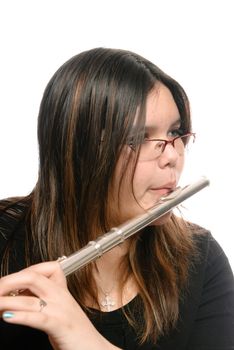 Closeup view of a young girl playing the flute, isolated against a white background.